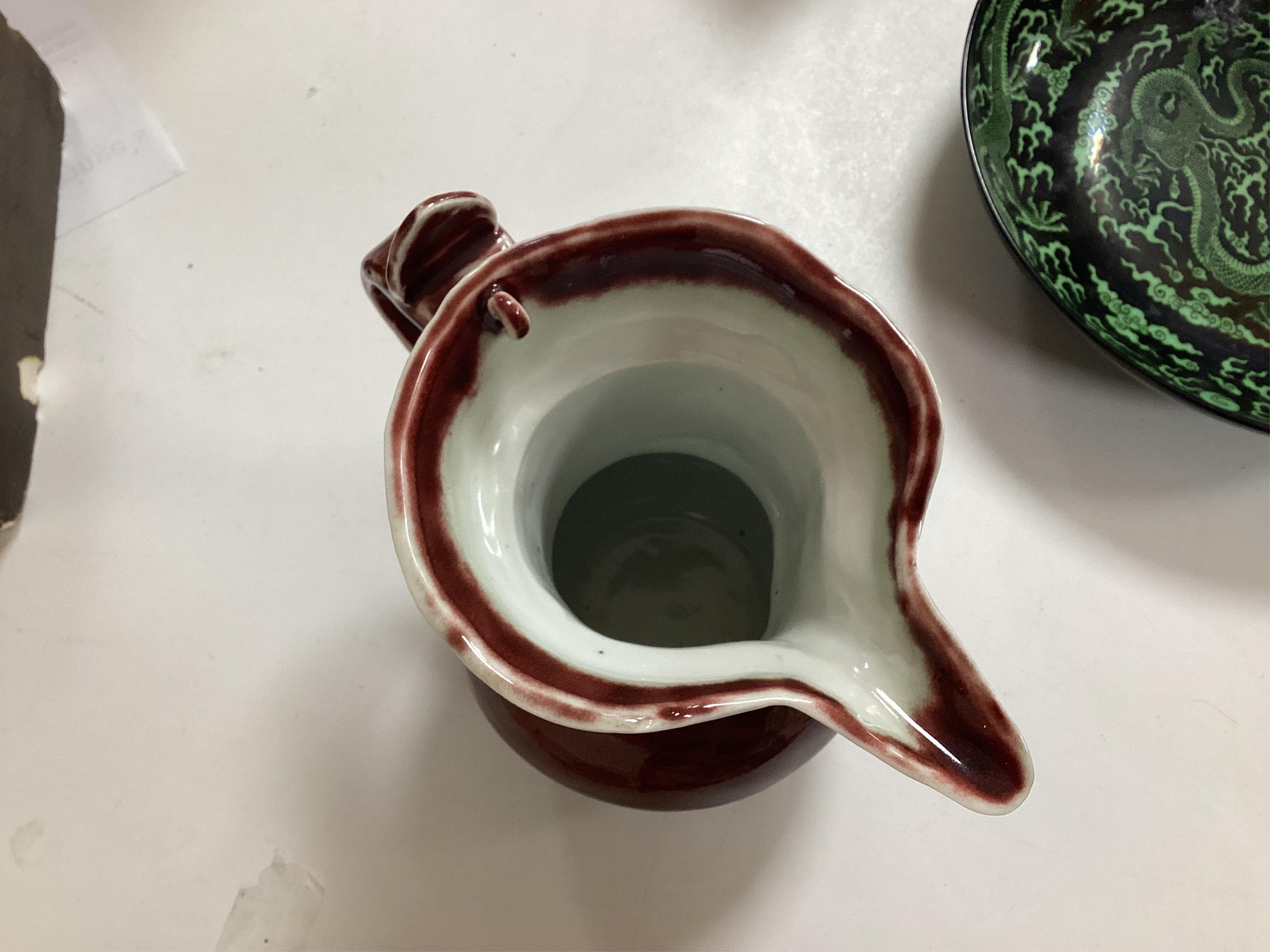 A Chinese famille noire ‘dragon’ dish, 22.5cm diameter, and a Sang de boeuf glaze monk’s cap ewer, Condition - good